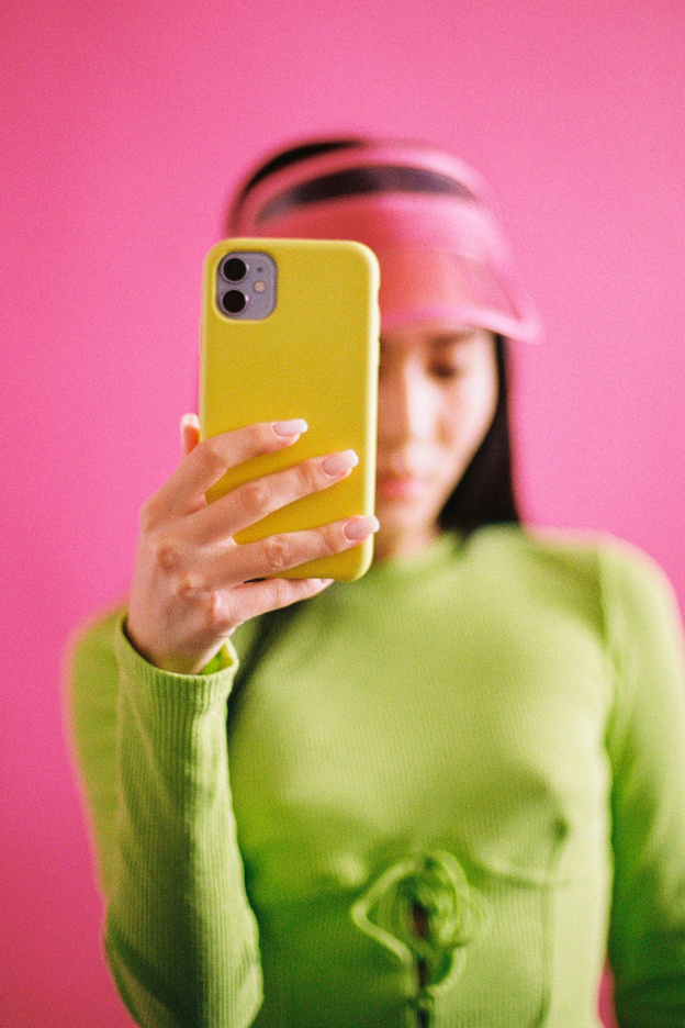 Woman Holding Phone in Yellow Phone Case